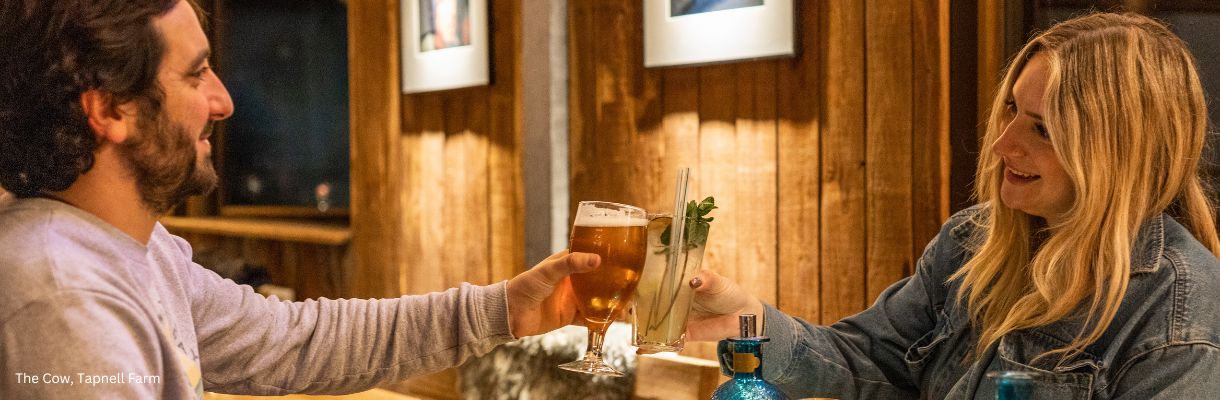 Couple enjoying a drink at The Cow, Tapnell Farm